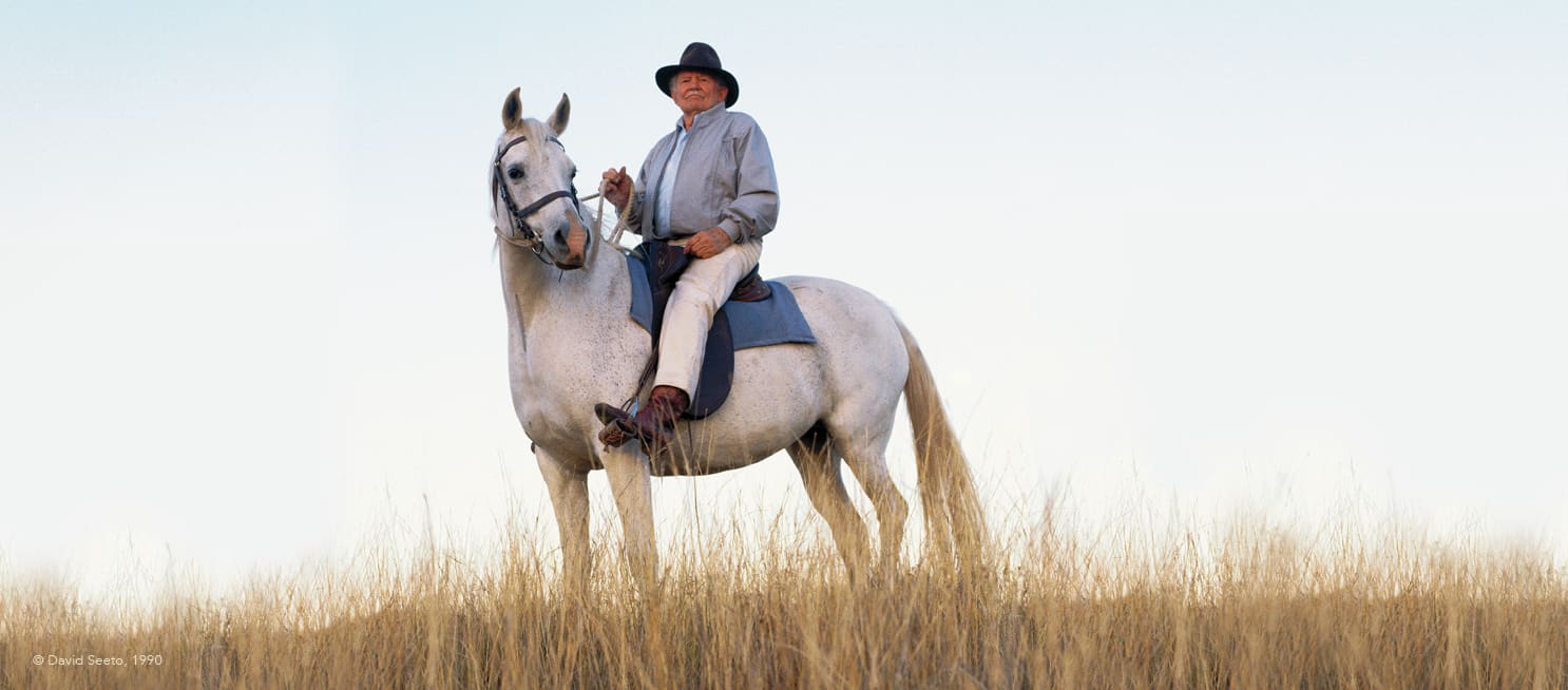 RM Williams founder sitting ontop of a white horse