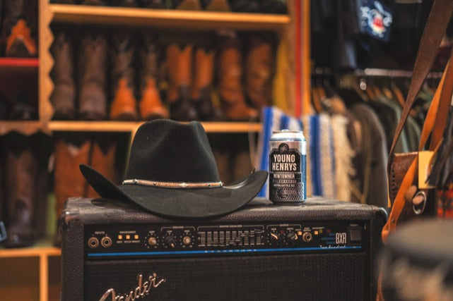 couple facing a stage with cowboy hat on